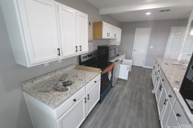 kitchen featuring dark wood-type flooring, electric range, white cabinetry, and light stone countertops