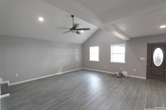 foyer entrance featuring ceiling fan, dark hardwood / wood-style floors, and vaulted ceiling with beams