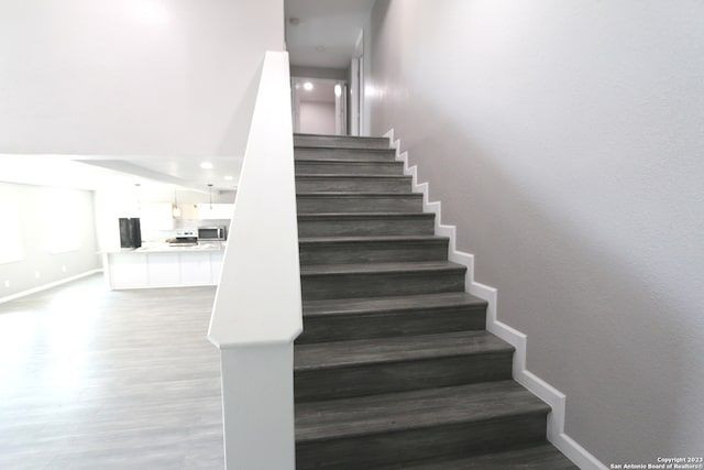 staircase featuring hardwood / wood-style flooring