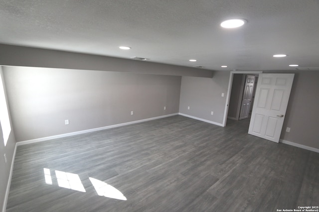 interior space featuring dark hardwood / wood-style floors and a textured ceiling