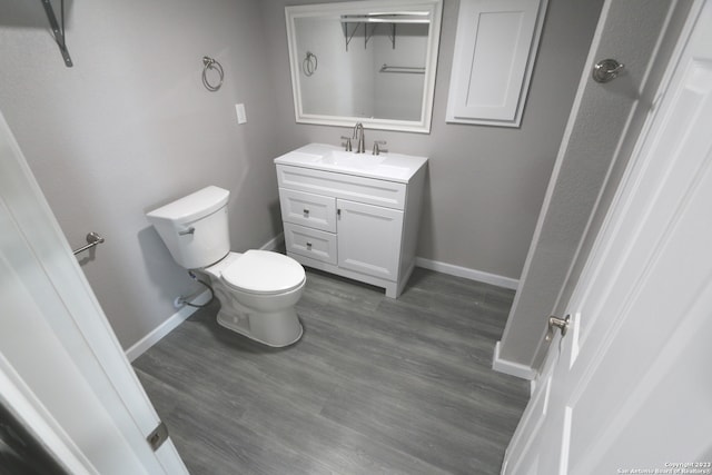 bathroom with vanity, hardwood / wood-style floors, and toilet