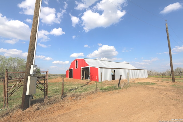 view of outdoor structure with a rural view