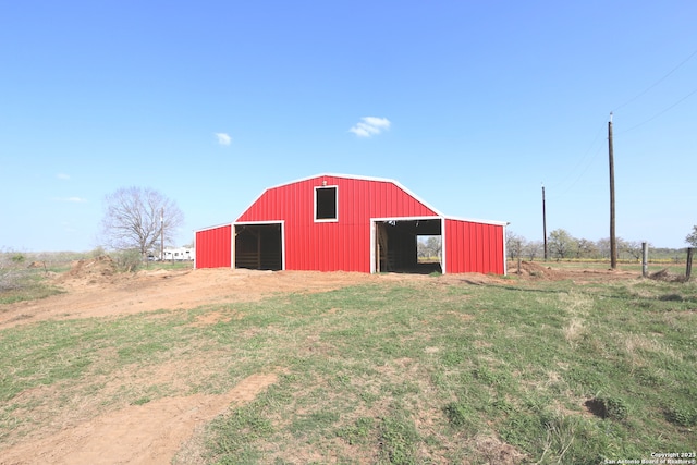 view of shed / structure with a rural view