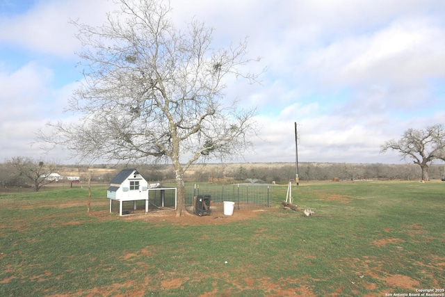 view of yard featuring an outbuilding and a rural view