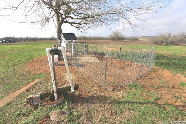 view of yard with an outbuilding and a rural view