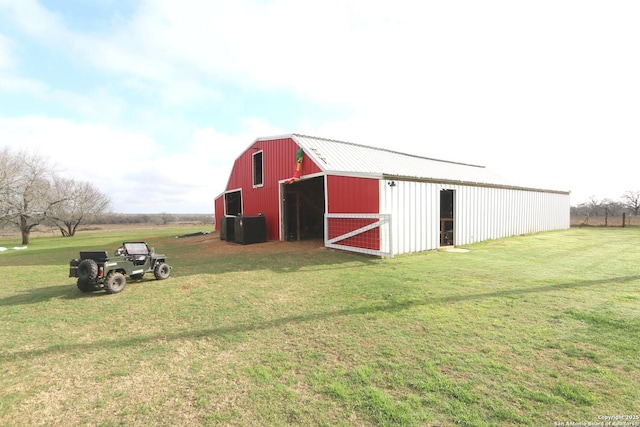 view of outbuilding featuring a lawn