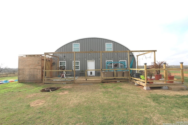 exterior space with a deck and a lawn