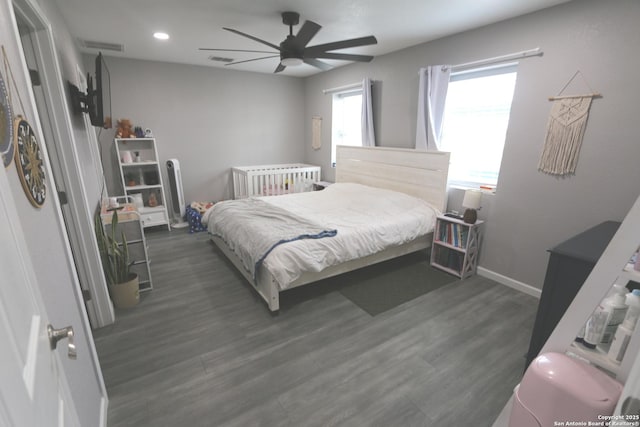 bedroom with dark hardwood / wood-style floors and ceiling fan