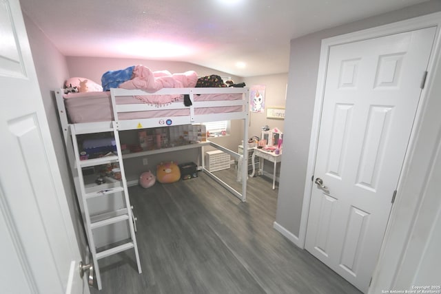 bedroom with dark hardwood / wood-style flooring and vaulted ceiling