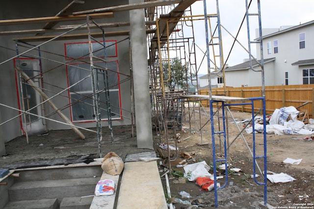 view of home's exterior with a playground and fence