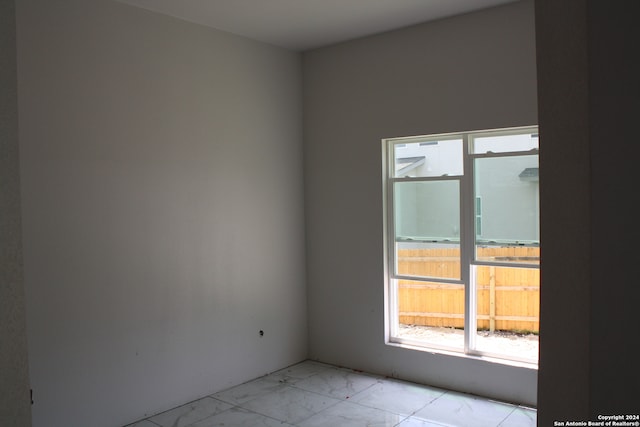 empty room featuring marble finish floor