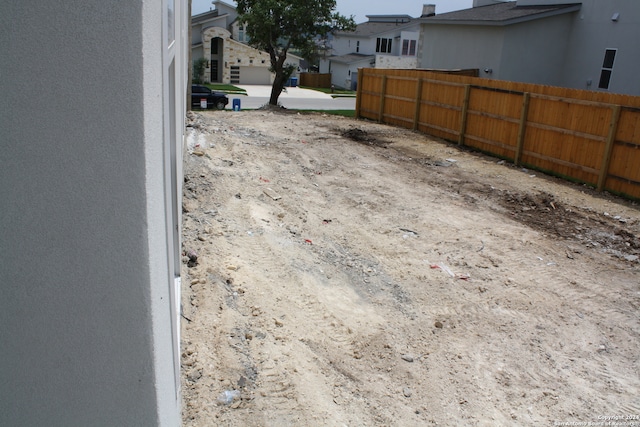 details featuring fence and stucco siding