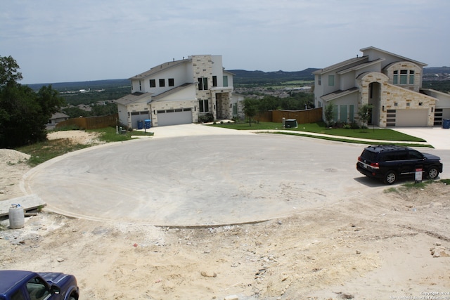 view of property exterior with driveway, stone siding, and stucco siding