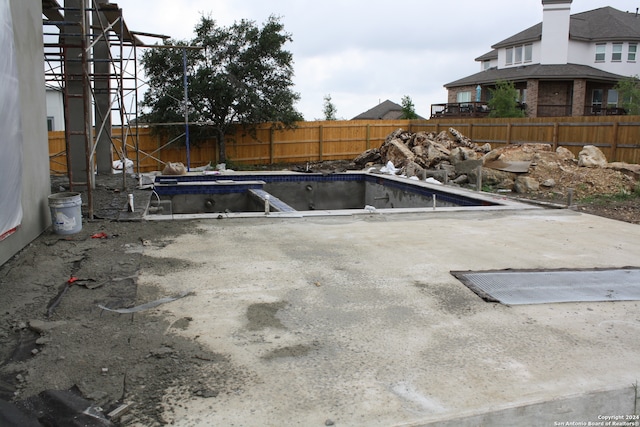 view of swimming pool featuring a fenced backyard, a fenced in pool, and a patio