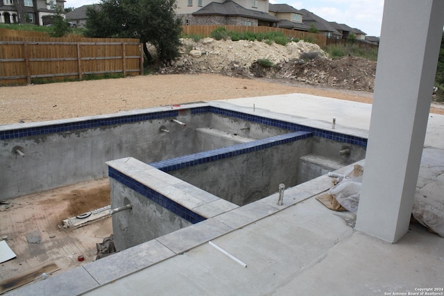 entry to storm shelter featuring fence