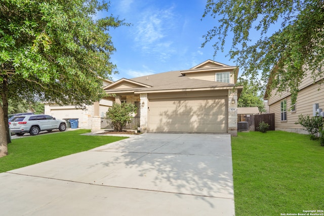 view of front of house with central AC, a garage, and a front yard