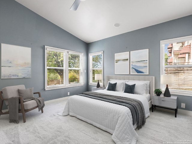 bedroom with ceiling fan, vaulted ceiling, and light colored carpet