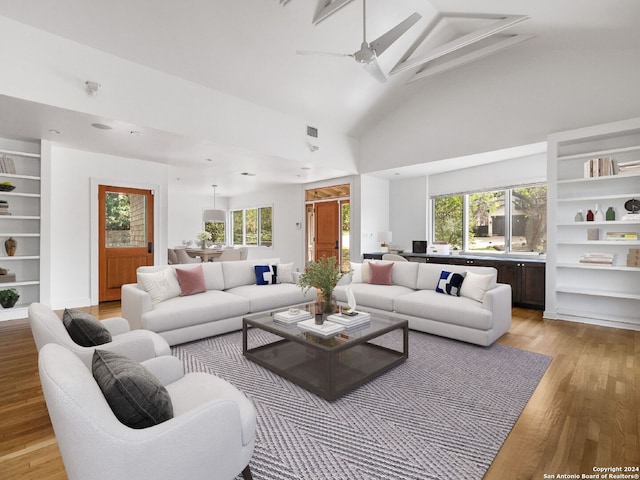 living room featuring light hardwood / wood-style floors, built in features, plenty of natural light, and ceiling fan