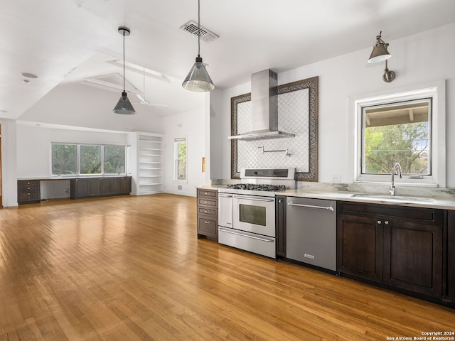 kitchen featuring light hardwood / wood-style flooring, stainless steel dishwasher, gas range oven, wall chimney range hood, and sink