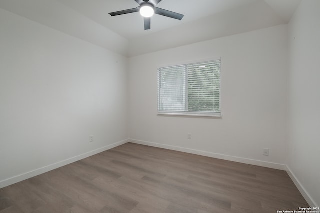 spare room featuring wood-type flooring and ceiling fan