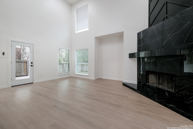 living room featuring wood-type flooring and a high end fireplace