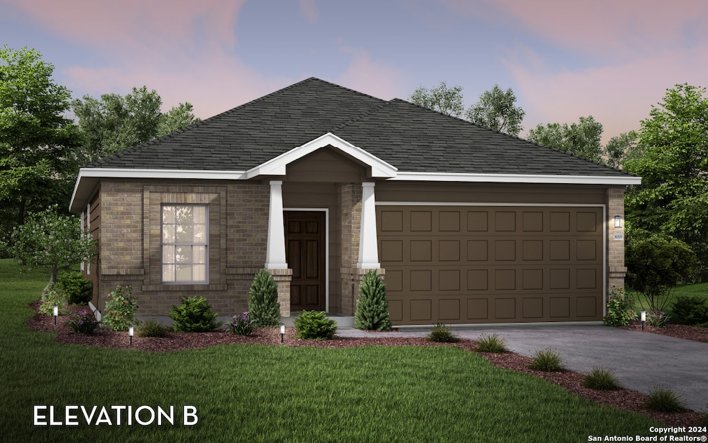 view of front of home with a garage and a yard