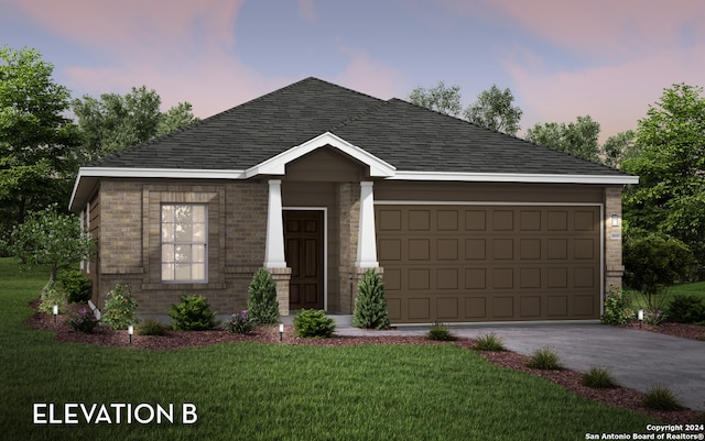 view of front of home with a garage and a yard