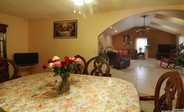 dining area featuring tile flooring, vaulted ceiling, and ceiling fan