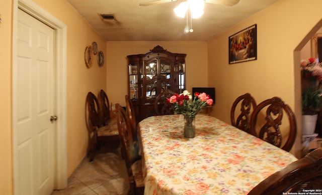 dining area featuring ceiling fan and tile floors