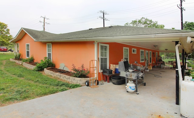 back of property featuring a yard and a patio