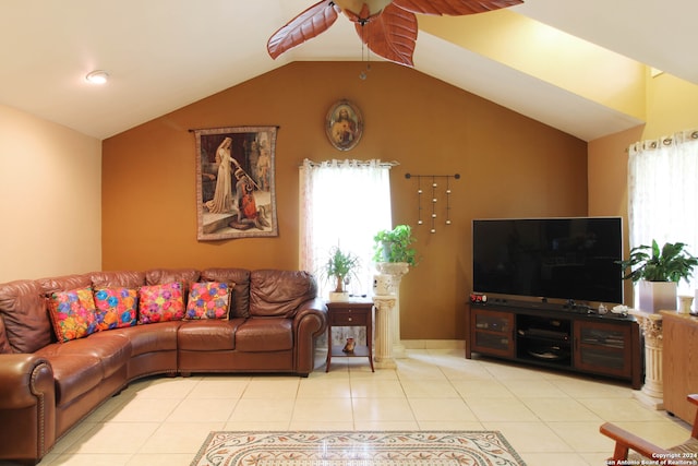 living room with ceiling fan, light tile floors, and lofted ceiling