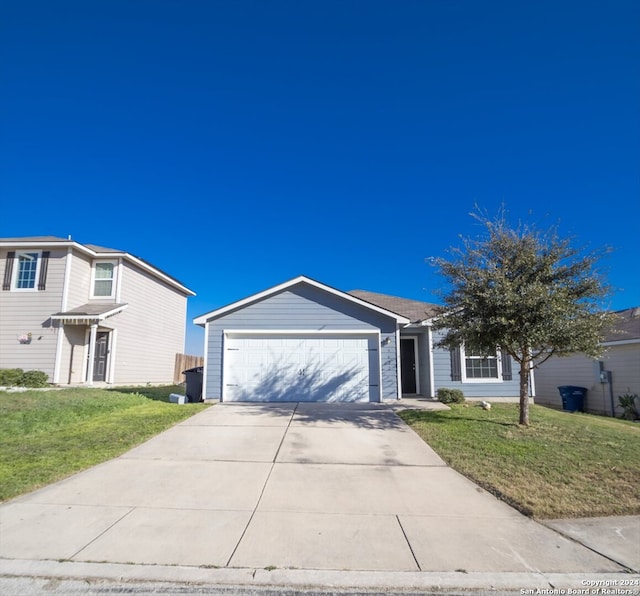 view of front of property featuring a front lawn and a garage