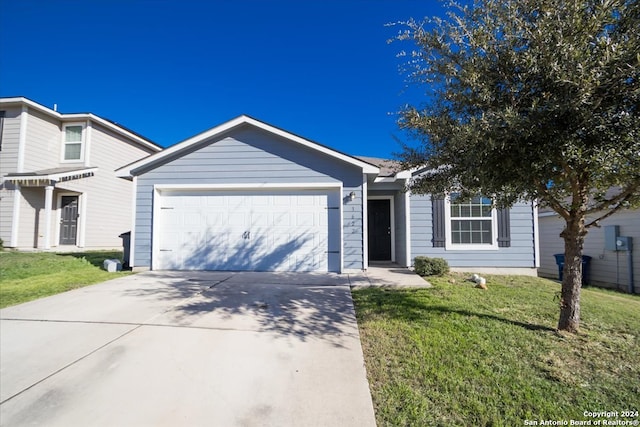 single story home featuring a garage and a front lawn