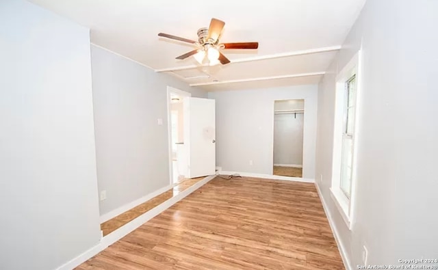 empty room featuring ceiling fan and light wood-type flooring