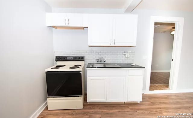 kitchen featuring white cabinets, ceiling fan, white electric stove, and light wood-type flooring