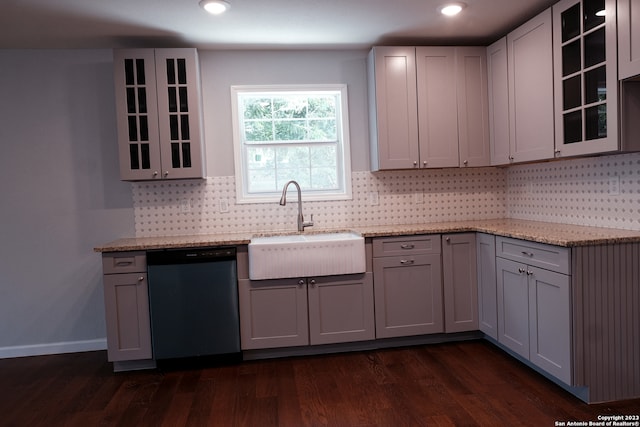 kitchen featuring light stone countertops, gray cabinets, dark hardwood / wood-style floors, sink, and dishwasher