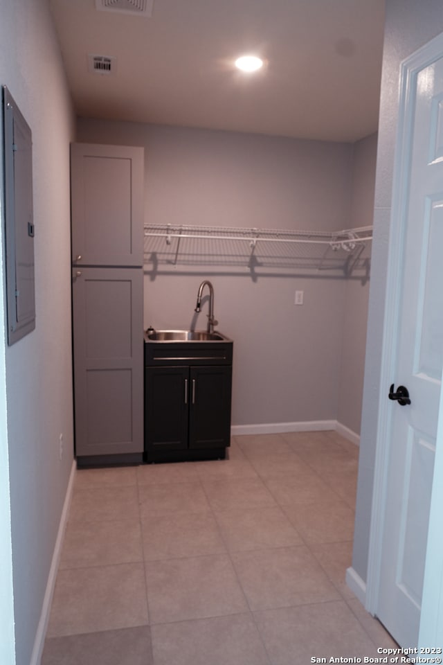 interior space with sink and light tile floors