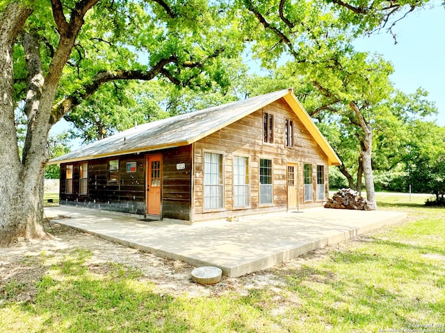 view of home's exterior featuring a patio area and a lawn