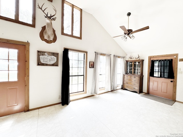 tiled foyer with plenty of natural light, ceiling fan, and high vaulted ceiling