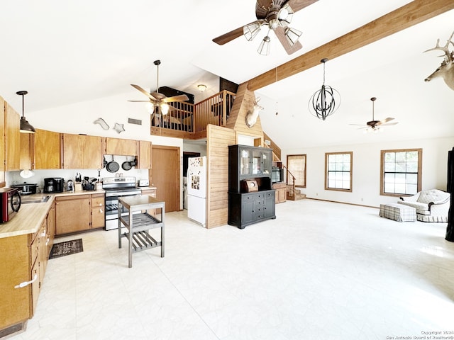 kitchen featuring pendant lighting, stainless steel range with electric cooktop, white fridge, and high vaulted ceiling