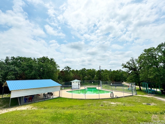 view of pool featuring a yard and an outdoor structure