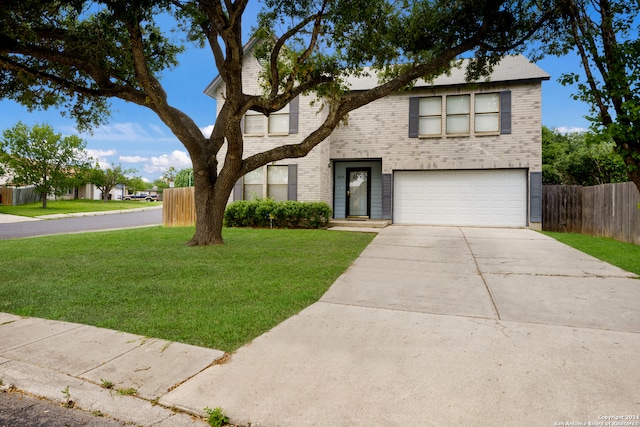 view of front of house featuring a garage and a front yard