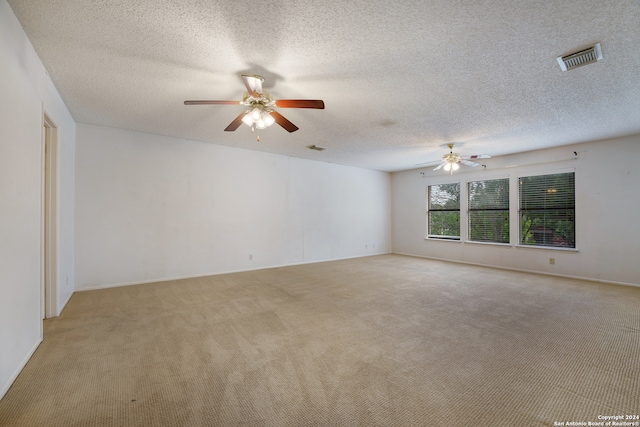 carpeted empty room with a textured ceiling and ceiling fan