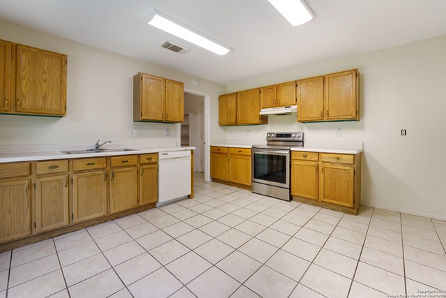 kitchen with light tile patterned floors, stainless steel electric range, white dishwasher, and sink