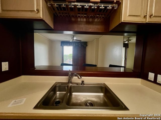 kitchen featuring ceiling fan and sink