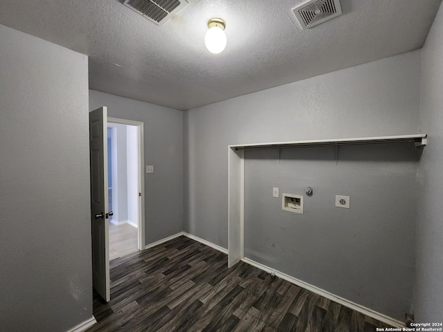 clothes washing area with electric dryer hookup, dark hardwood / wood-style floors, gas dryer hookup, hookup for a washing machine, and a textured ceiling