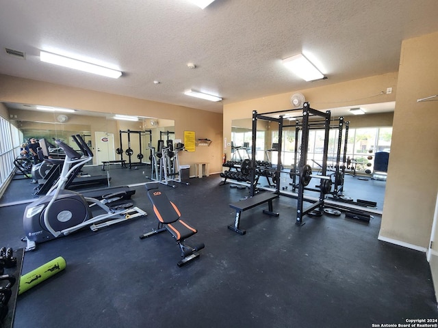 exercise room with a textured ceiling