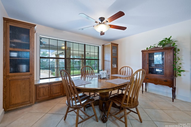 dining space with light tile patterned floors and a ceiling fan