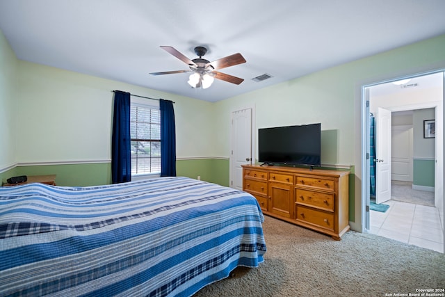 tiled bedroom featuring ceiling fan