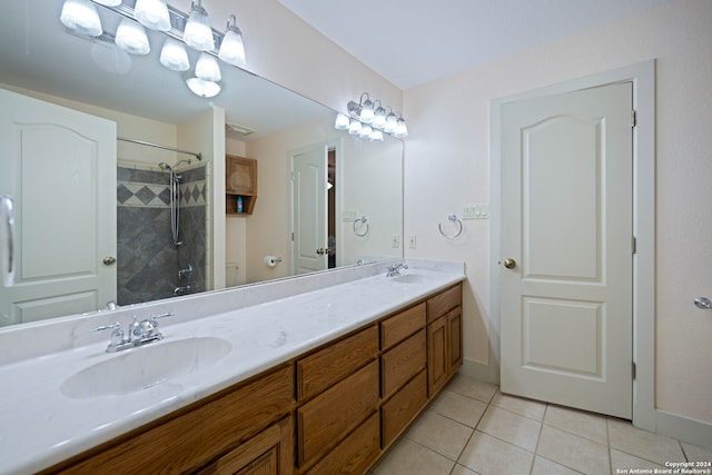 bathroom with tile patterned flooring, a shower with door, and vanity